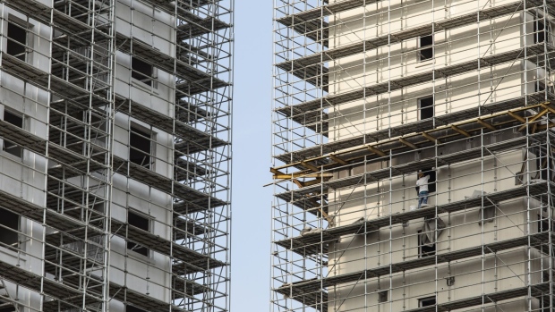 A construction worker labors on the scaffolding of a building at an under construction residential housing development in Shanghai, China, on Thursday, July 29, 2021. Chinese policy-making bodies collectively issued a three-year timeline for bringing “order” to the property sector, long under scrutiny due to an excessive buildup of leverage among home-buyers and developers. Photographer: Qilai Shen/Bloomberg