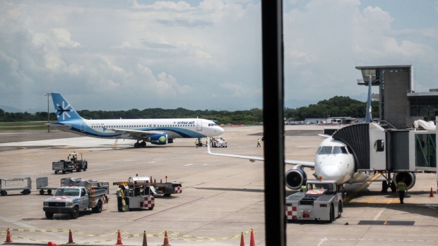 An ABC Aerolineas SA Interjet plane taxis to the gate at Licenciado Gustavo Diaz Ordaz International Airport (PVR) in Puerto Vallarta, Mexico, on Friday, Aug. 25, 2017. Mexico's consumer-protection agency fined five airlines including New York-based JetBlue a combined 22.4 million pesos ($1.27 million) for alleged transgressions such as charging fliers for their first checked bag. The entity, not known for taking on major corporations, is also monitoring whether airlines comply with a new requirement to compensate passengers when flights have major delays.