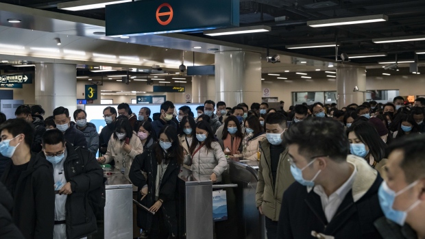 Commuters wearing protective masks make their way through a subway station during the morning rush hour in Shanghai, China, on Friday, Aug. 6, 2021. China is facing a delta-driven coronavirus resurgence that's grown to more than 500 cases scattered across half the country. Photographer: Qilai Shen/Bloomberg