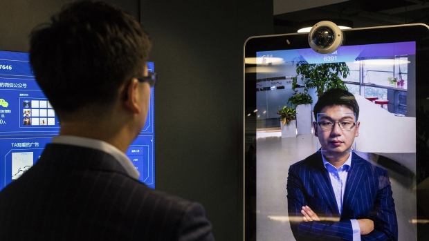 Xu Li, chief executive officer of SenseTime Group Ltd., is identified by the company's facial recognition system on a screen as he poses for a photograph at SenseTime's showroom in Beijing, China, on Friday, June 15, 2018. SenseTime's image-identifying algorithms have made it the world's most valuable AI startup and an early leader in China, where it's won contracts with the country's top phonemakers, largest telecommunications company, and biggest retailer.