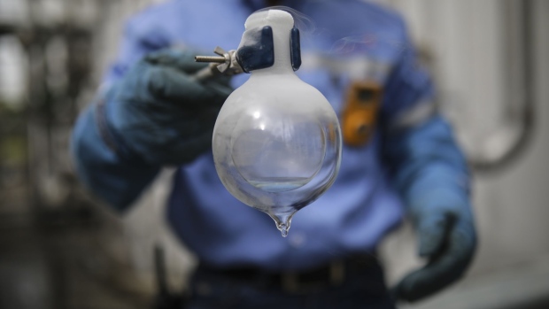 A worker displays extracted liquid oxygen at the Messer Group medical oxygen production facility in Tocancipa, Colombia, on Monday, Feb. 1, 2021. Several neighborhoods in Colombia's capital will be placed under lockdown starting Saturday, affecting roughly 1.5 million residents, as hospital ICU beds remain more than 90% full.