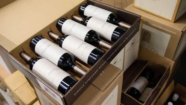 Bottles of red wine sit in a cardboard delivery case ahead of shipping at the Schmidheiny Weingut, a vineyard owned by Thomas Schmidheiny, billionaire and Holcim Ltd. shareholder, in Heerbrugg, Switzerland, on Thursday, April 24, 2014. Schmidheiny inherited a cement company from his father that's poised to become the worlds biggest., but what really excites the Swiss billionaire is a wine sideline with sales of about 0.1 percent of the cement revenue. Photographer: Bloomberg/Bloomberg