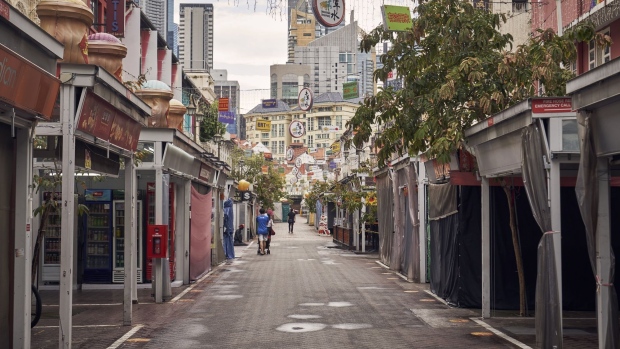 A deserted street in the Chinatown area of Singapore, on Tuesday, Aug. 3, 2021. Daily virus case counts in Singapore have stayed well above 100 since July 19, after an outbreak at a fishery port led government officials to reimpose tighter Covid restrictions. Photographer: Lauryn Ishak/Bloomberg