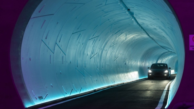 A Tesla Inc. electric vehicle passes through an underground tunnel during a tour of the Boring Co. Convention Center Loop in Las Vegas, Nevada, U.S., on Friday, April 9, 2021. Once operational, Tesla vehicles capable of carrying up to 16 passengers will shuttle through the tunnel, turning a 1.5 mile walk on the surface into a trip that takes a couple of minutes.