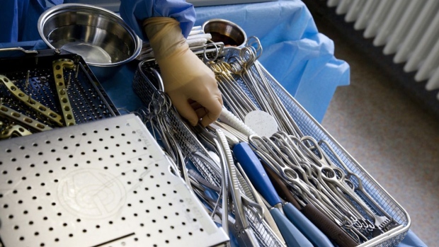 A member of the medical team checks instruments during an operation in the operating theater at a hospital in Germany. Photographer: Bloomberg Creative Photos/Bloomberg