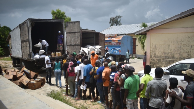 Residents wait in line to receive food aid in Port-Salut, Haiti.