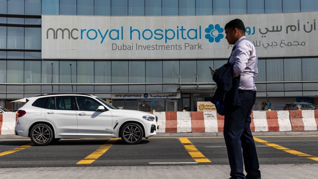 A pedestrian waits outside the entrance to the NMC Royal Hospital, operated by NMC Health Plc, in Dubai, United Arab Emirates, on Sunday, March 1, 2020. Troubled NMC Health Plc, the largest private health-care provider in the United Arab Emirates, asked lenders for an informal standstill on its debt as Dubai weighs an injection of capital to safeguard the emirate’s reputation among global investors.