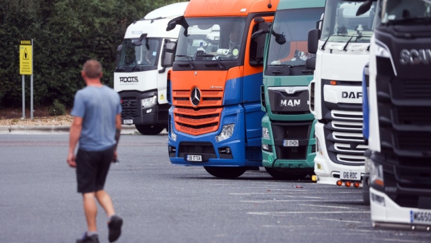A driver passes a row of trucks at a service station near Thurrock, U.K., on Friday, Sept. 3, 2021. The U.K. is running out of time to find more truck drivers before isolated incidents at supermarkets and fast-food chains erupt into a deeper crisis that leaves businesses crippled by delivery delays and shortages.