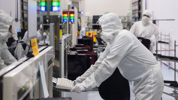 Technicians in the cleanroom at the Interuniversity Microelectronics Centre (imec), in Leuven, Belgium, on Wednesday, July 7, 2021. The Interuniversity Microelectronics Centre may be Belgium’s best-kept secret, but it’s in global demand for its work on the future of computer chips, with applications in areas from genome sequencing to autonomous driving. Photographer: Olivier Matthys/Bloomberg