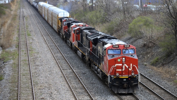 A Canadian National Railway locomotive pulls a train in Montreal, Quebec, Canada, on Tuesday, April 20, 2021. Canadian National Railway Co. offered $30 billion to snatch Kansas City Southern away from a rival, spurring a possible bidding war over one of the industrys biggest deals in decades. Photographer: Christinne Muschi/Bloomberg