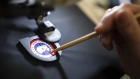 An employee arranges a logo patch in a sewing machine at the new Canada Goose Inc. manufacturing facility in Montreal, Quebec, Canada, on Monday, April 29, 2019. The facility is Canada Goose's second factory in Quebec and eighth wholly-owned facility in Canada. Photographer: Christinne Muschi/Bloomberg