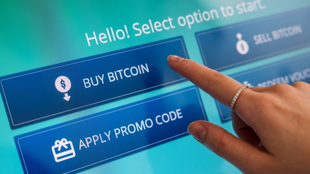 An employee selects the "Buy Bitcoin" option on a cryptocurrency automated teller machine (ATM) during a demonstration at the Hong Kong Digital Asset Exchange Ltd. digital currency trading store in Hong Kong, China, on Thursday, June 24, 2021. Hong Kong Digital Asset Exchange is a cryptocurrency platform and is the first to combine online and physical exchange in Hong Kong. Photographer: Bloomberg/Bloomberg