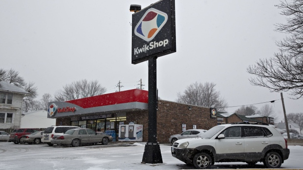 Vehicles sit parked outside a Kwik Shop Inc. convenience store in Davenport, Iowa.