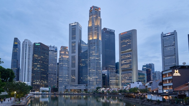 Commercial real estate in the central business district beyond restaurants and bars in the Boat Quay area of Singapore. Photographer: Lauryn Ishak/Bloomberg