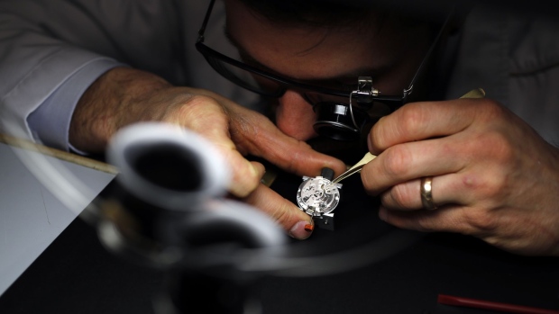 A watch maker works on the movement of a timepiece at the Jaeger-LeCoultre stand, a unit of Cie. Financiere Richemont SA, during the Salon International de la Haute Horlogerie (SIHH) in Geneva, Switzerland, on Tuesday, Jan. 15, 2019. The elephant in the room at this week’s Swiss watch fair in Geneva is that the industry is still struggling to find buyers for all the timepieces it has produced over the years. Photographer: Stefan Wermuth/Bloomberg
