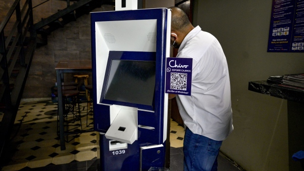 A worker fixes a Chivo Bitcoin automated teller machine (ATM) in San Salvador, El Salvador, on Tuesday, Sept. 7, 2021. El Salvador's experiment using Bitcoin had a rocky start as its price crashed on its first day as legal tender, while the roll-out was hampered by technical glitches. Photographer: Camilo Freedman/Bloomberg