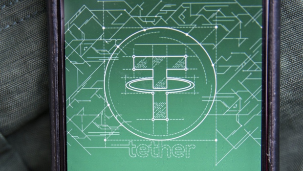The Tether logo is seen on a smartphone in this arranged photograph taken in Washington, D.C., U.S., on Tuesday, Dec. 5, 2017. Tether, which started trading in 2015, is described as a stable alternative to bitcoin's wild price swings. Photographer: Andrew Harrer/Bloomberg