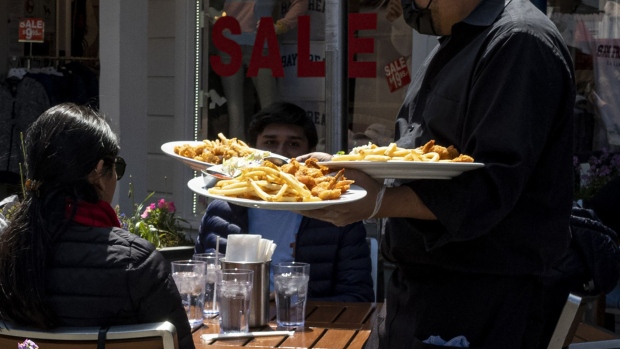 A worker serves food at a restaurant on Pier 39 in San Francisco.
