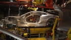 The part-complete metal body shell of a luxury Jaguar automobile travels along the production line at the company's assembly plant in Castle Bromwich, U.K.
