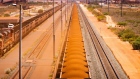 A freight train carrying iron ore travels along a rail track towards Port Hedland, Australia, on Monday, March 18, 2019. A two-day drive from the nearest big city, Perth, Port Hedland is the nexus of Australia’s iron-ore industry, the terminus of one of Australia’s longest private railways that hauls ore about 400 kilometers (250 miles) from the mines of BHP Group and Fortescue Metals Group Ltd. The line ran a record-breaking test train weighing almost 100,000 tons that was more than 7 kilometers long in 2001, and even normal trains haul up to 250 wagons of ore. Photographer: Ian Waldie/Bloomberg