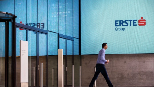 A man walks in front of logo of Erste Group Bank AG as he exits the headquarters in Vienna, Austria, on Friday, Aug. 4, 2017. Austria's biggest bank reported net income of 362.5 million euros ($431 million) in the three months to June, a 36 percent drop from a year earlier as some one-time effects didn’t recur. Photographer: Lisi Niesner/Bloomberg