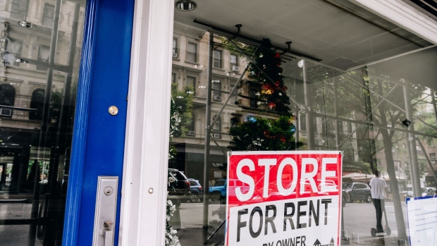A "Store for Rent" sign hangs in a window of a store on Madison Avenue in New York, U.S., on Saturday, Sept. 26, 2020. The pandemic has battered New York City businesses, with almost 6,000 closures, a jump of about 40% in bankruptcy filings across the region and shuttered storefronts in the business districts of all five boroughs.