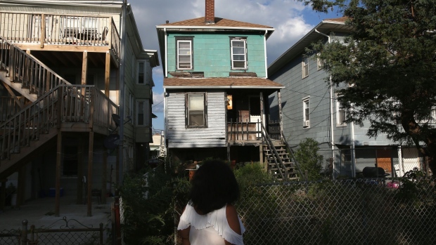 ATLANTIC CITY, NJ - AUGUST 26: Valencia Terrell looks to an abandoned foreclosed home on August 26, 2015 in Atlantic City, New Jersey. Terrell, worked in casino VIP services for years before her home was destroyed in Hurricane Sandy and she had to leave work to take care of family members. She now survives with the aid of food stamps and takes her family members to a soup kitchen for additional meals. After years of decline in Atlantic City, in 2014 some 8,000 people were layed-off when four of the city's major casinos closed, bringing Atlantic City's unemployment rate to more than 11 percent, double the national average. As unemployment assistance has begun to expire for many people, shelters like the Atlantic City Rescue Mission have seen a large jump in need. They serve upwards of 700 meals and house some 300 people a day, including many families. The mass unemployment has produced the highest foreclosure rate of any metropolitan U.S. area, with 1 out of 113 homes now in foreclosure in Atlantic County. (Photo by John Moore/Getty Images) Photographer: John Moore/Getty Images North America
