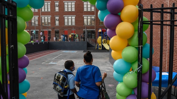 A student arrives on the first classes at a public school in the Bronx borough in New York, U.S., on Monday, Sept. 13, 2021. For the first time since the beginning of the Covid-19 pandemic, all of New York City’s public school students are expected to return to classes in person on Monday. Photographer: Stephanie Keith/Bloomberg