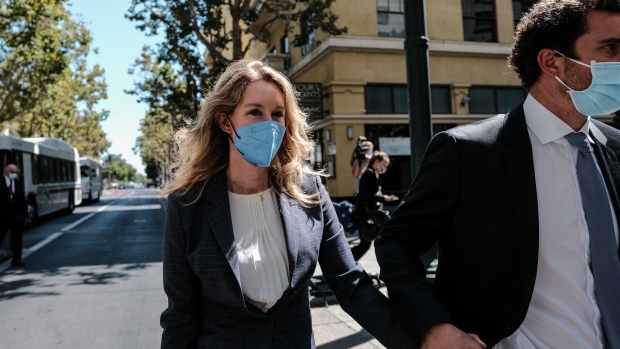 Elizabeth Holmes, founder of Theranos Inc., and husband Billy Evans exit federal court in San Jose, California, U.S., on Wednesday, Sept. 8, 2021. Holmes, 37, faces a dozen fraud and conspiracy counts that could send her to prison for as long as 20 years if shes convicted.