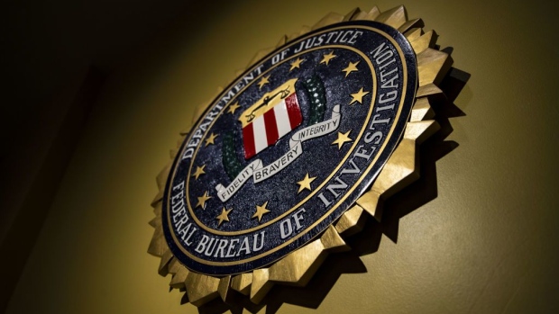 The seal of the Federal Bureau of Investigation (FBI) hangs on a wall before a news conference at the FBI headquarters in Washington, D.C., U.S., on Thursday, June 14, 2018. Former FBI Director James Comey was "insubordinate" in handling the probe into Hillary Clinton, damaging the bureau and the Justice Department's image of impartiality even though he wasn't motivated by politics, the department's watchdog said today. Photographer: Bloomberg/Bloomberg