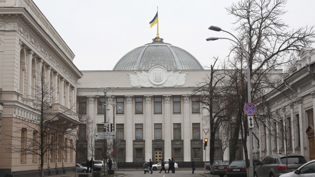 A Ukrainian national flag flies above the national parliament building, also known as the Verkhova Rada, in Kiev, Ukraine, on Tuesday, Feb. 23, 2016. The face of Ukraines Orange Revolution a decade ago, she became prime minister before infighting sank the pro-democracy government and allowed its Russian-backed adversary to take charge.
