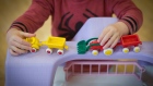 RADSTOCK, UNITED KINGDOM - JANUARY 06: A young boy plays with toys at a playgroup for pre-school aged children in Chilcompton near Radstock on January 6, 2015 in Somerset, England. Along with the health and the economy, education and childcare are to be key issues in the forthcoming election. 