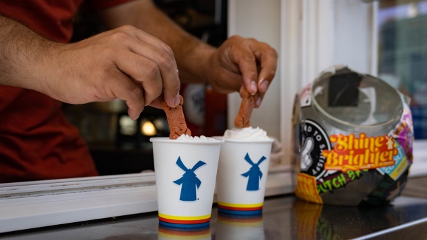A barista prepares dog treat drinks for a customer at the drive-through window of a Dutch Bros. Coffee location in Beaverton, Oregon, U.S., on Thursday, June 24, 2021. Dutch Bros. The privately-held chain has recently filed confidentially for an initial public offering. Photographer: Maranie Staab/Bloomberg