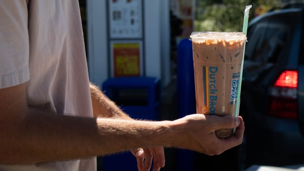 An employee delivers a drink to a customer outside a Dutch Bros. Coffee location in Beaverton, Oregon.