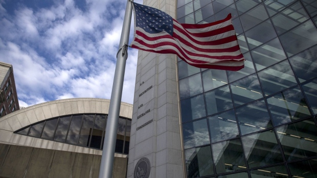An American flag flies outside the headquarters building of the U.S. Securities and Exchange Commission (SEC) in Washington, D.C., U.S., on Dec. 22, 2018. Parts of the U.S. government shut down on Saturday for the third time this year after a bipartisan spending deal collapsed over President Donald Trump's demands for more money to build a wall along the U.S.-Mexico border.