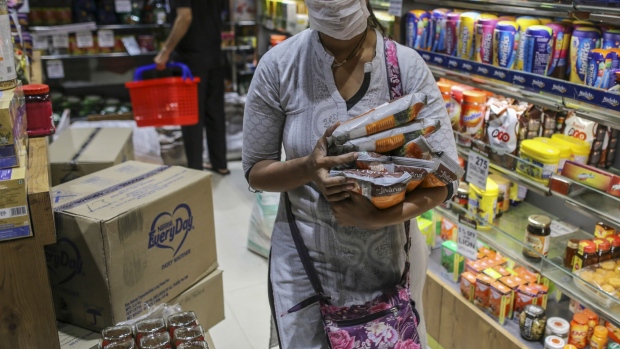 A customer wearing a protective mask shops in a supermarket in Mumbai, India, on Wednesday, March 25, 2020. India imposed a three-week long nationwide lockdown for its 1.3 billion people, the most far-reaching measure undertaken by any government to curb the spread of the coronavirus pandemic. Photographer: Dhiraj Singh/Bloomberg