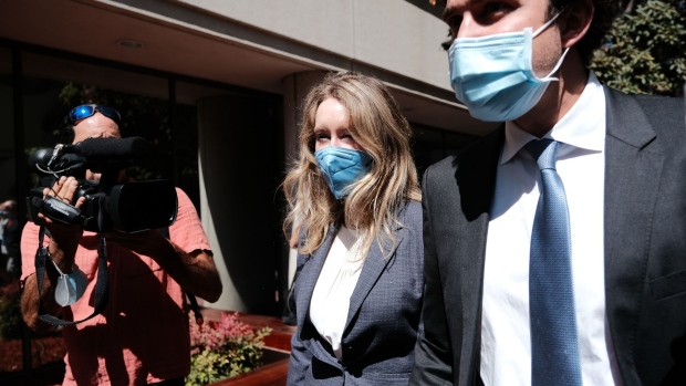 Elizabeth Holmes, founder of Theranos Inc., and husband Billy Evans exit federal court in San Jose, California, on Sept. 8.