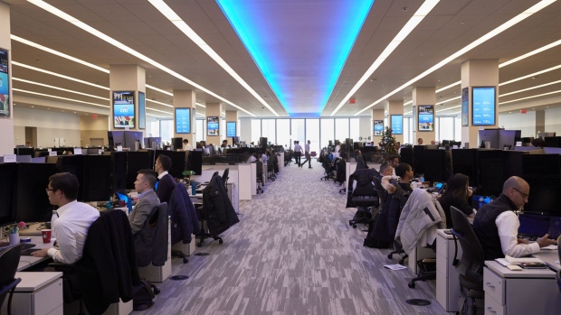 Employees work on the trading floor at the new Citigroup Inc. headquarters in New York, U.S., on Tuesday, Dec. 3, 2019. Citigroup's trading floors - long known for being festooned with flags marking the home countries of its hundreds of traders, and banners touting years of good performance - have gotten swankier, with floor-to-ceiling windows, desks outfitted with 43-inch computer monitors and small cafeterias on every floor. Photographer: Marc McAndrews/Bloomberg