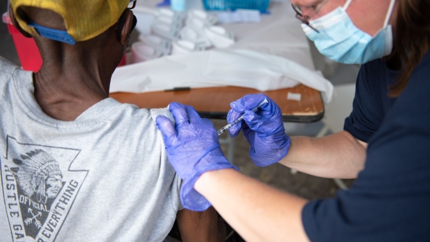A healthcare worker administers a dose of the Pfizer-BioNTech Covid-19 vaccine during a vaccination event in Birmingham, Alabama, U.S., on Saturday, Aug. 28, 2021. Covid-19 hospitalization numbers and deaths continue to climb in Alabama as the state grapples with the most recent surge. Photographer: Andi Rice/Bloomberg