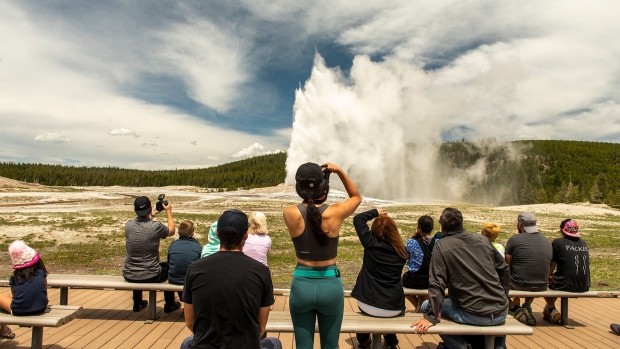 YELLOWSTONE NATIONAL PARK, WY - JUNE 01: Visitors attempt social distancing as they watch Old Faithful geyser erupt when Montana gates opened for day trips on June 1, 2020 in Yellowstone National Park, Wyoming. The park's Montana entrances opened as the state enters phase 2 of lifting lockdown measures imposed due to the COVID-19 pandemic. (Photo by William Campbell/Getty Images)