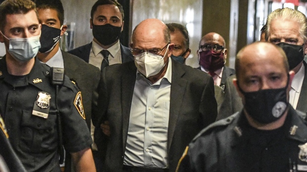 Allen Weisselberg, center, walks towards a courtroom at criminal court in New York, on July 1.