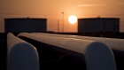 The sun rises beyond oil storage tanks at the Enbridge Inc. Cushing storage terminal in Cushing, Oklahoma, U.S., on Wednesday, March 25, 2015.