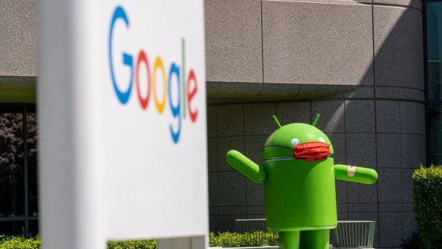 An Android statue wearing a mask on the Google campus in Mountain View, California, U.S., on Wednesday, April 21, 2021. Silicon Valley has the lowest office vacancy rate in the U.S., even as technology companies embrace remote work. Photographer: David Paul Morris/Bloomberg