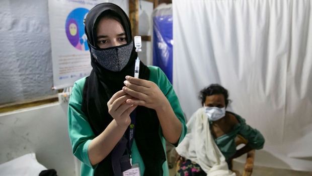COX'S BAZAR, BANGLADESH - AUGUST 11: A nurse fills a syringe with a COVID-19 vaccine in a Rohingya refugee camp on August 11, 2021 in Cox's Bazar, Bangladesh. On Tuesday, Bangladesh started a COVID-19 vaccination drive for Rohingya refugees. Nearly 48,000 Rohingya refugees will be inoculated with the help of the UN agencies. (Photo by Allison Joyce/Getty Images)