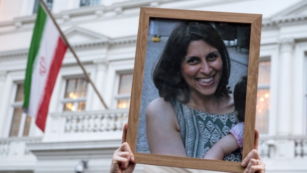 A supporter holds a photo of Nazanin Zaghari-Ratcliffe during a vigil in 2017.