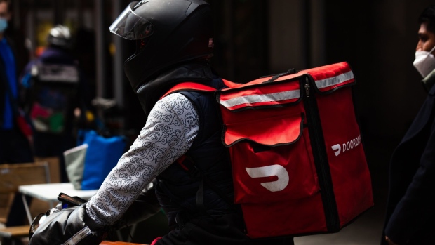 A demonstrator wearing a Doordash backpack in Times Square during a march for food delivery workers rights in New York, U.S., on Wednesday, April 21, 2021. Delivery workers are calling on the city to grant them further labor protections, including enhanced safety provisions, access to bathrooms, and more regulation of the apps, Gothamist reports. Photographer: Paul Frangipane/Bloomberg