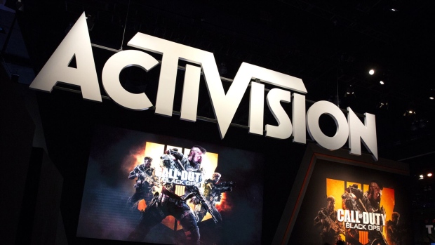 Attendees stand next to signage for Activision Blizzard Inc. Call Of Duty: Black Ops 4 video game during the E3 Electronic Entertainment Expo in Los Angeles. Photographer: Troy Harvey/Bloomberg