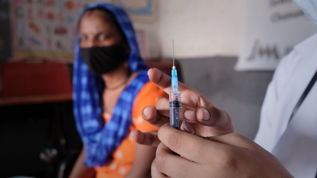 A health worker prepares a dose of the Covid-19 Covishield vaccine at a vaccination camp set up at Sewa Kendra Aaganbadi School in the Sanjay Camp area of New Delhi, India, on Sunday, Sept. 19, 2021. India, with the second largest Covid outbreak with over 33 million infections, has administered some 758 million vaccine doses, but even with that large number only a little over 13% of the country's population is fully vaccinated, according to the Bloomberg Vaccine Tracker.