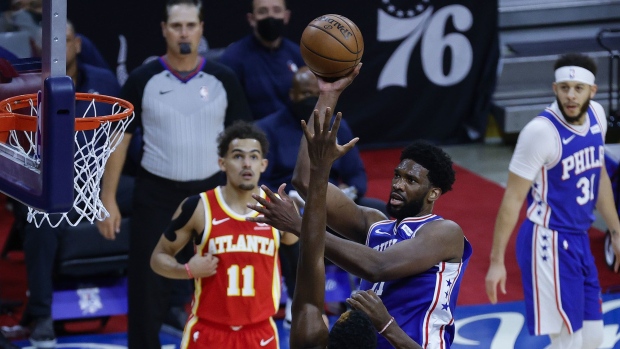 Joel Embiid #21 of the Philadelphia 76ers shoots over Clint Capela #15 of the Atlanta Hawks during the first quarter during Game Five of the Eastern Conference Semifinals at Wells Fargo Center on June 16, 2021 in Philadelphia.