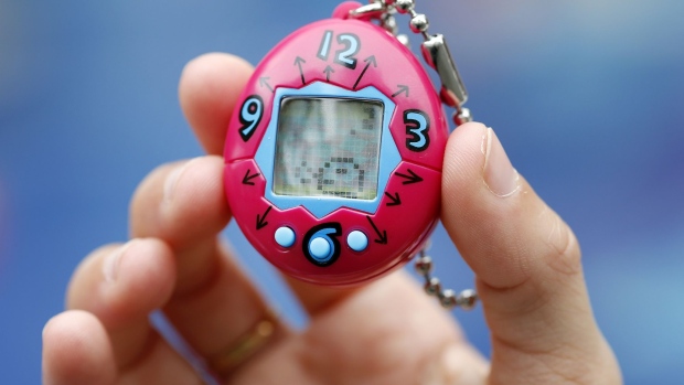 PARIS, FRANCE - OCTOBER 25: A child shows a "Tamagotchi" electronic pet on October 25, 2017 in Paris, France. Tamagotchi is a virtual electronic animal which means "cute little egg" and simulates the life of an animal. Twenty years after its creation, the Japanese company Bandai reissues the famous limited edition toy that is available today in France. Tamagotchi will be available in the United States on November 5, 2017. 